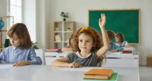 young girl in classroom setting with her hand raised